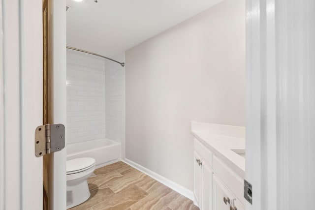 full bathroom featuring tiled shower / bath, vanity, and toilet