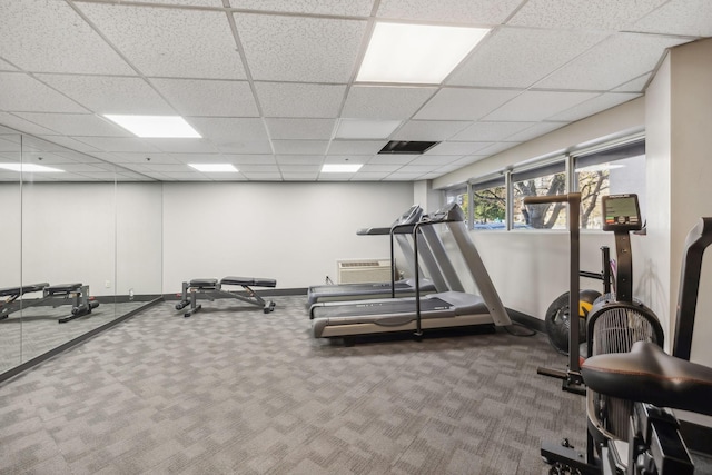 exercise area with a drop ceiling and carpet floors