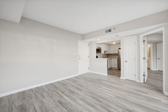 unfurnished living room with light wood-type flooring