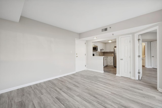 900 19th Ave S Unit 103, Nashville, TN 37212 - unfurnished living room with light wood-type flooring