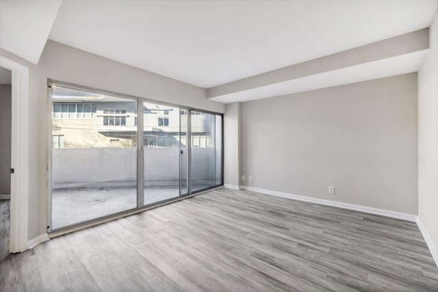 900 19th Ave S Unit 103, Nashville, TN 37212 - unfurnished room featuring wood finished floors and baseboards