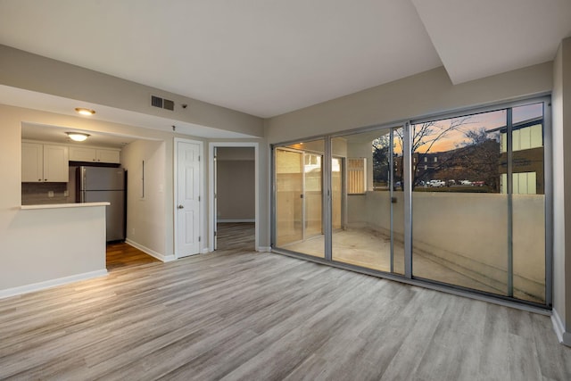 unfurnished living room with light hardwood / wood-style flooring