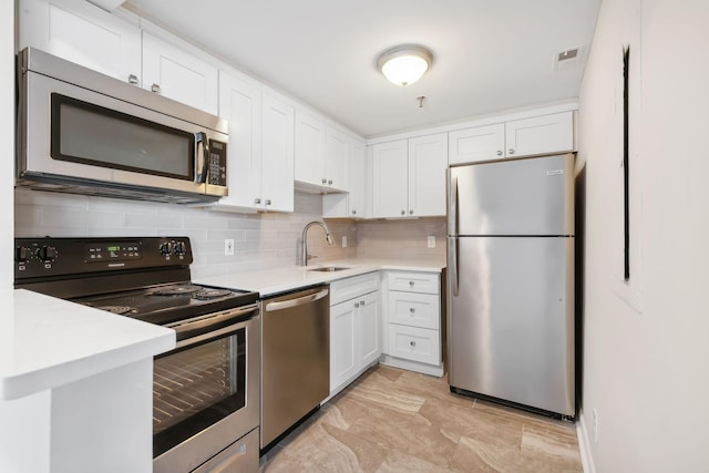 kitchen featuring sink, white cabinetry, and stainless steel appliances