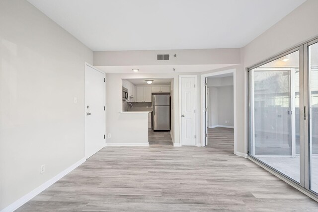 900 19th Ave S Unit 103, Nashville, TN 37212 - unfurnished living room featuring light wood-type flooring