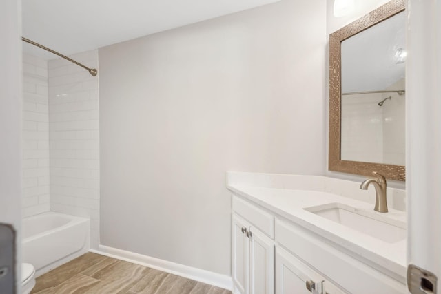 bathroom with vanity, wood-type flooring, and tiled shower / bath combo