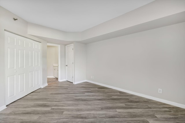 unfurnished bedroom featuring hardwood / wood-style floors and a closet