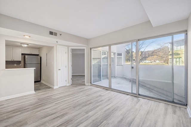 unfurnished living room featuring light wood-type flooring