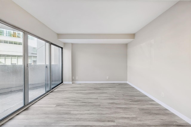 spare room with light hardwood / wood-style flooring