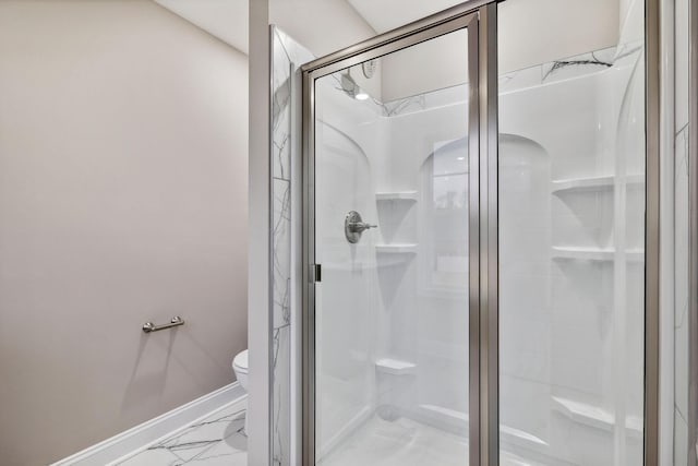 bathroom featuring toilet and an enclosed shower