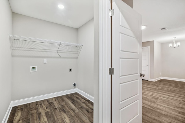 laundry area with hookup for an electric dryer, washer hookup, dark hardwood / wood-style flooring, and a notable chandelier