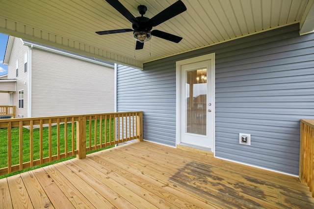 deck featuring a yard and ceiling fan