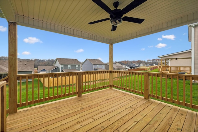 deck featuring ceiling fan and a yard