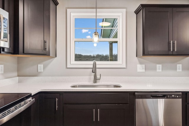 kitchen featuring pendant lighting, sink, a healthy amount of sunlight, and appliances with stainless steel finishes