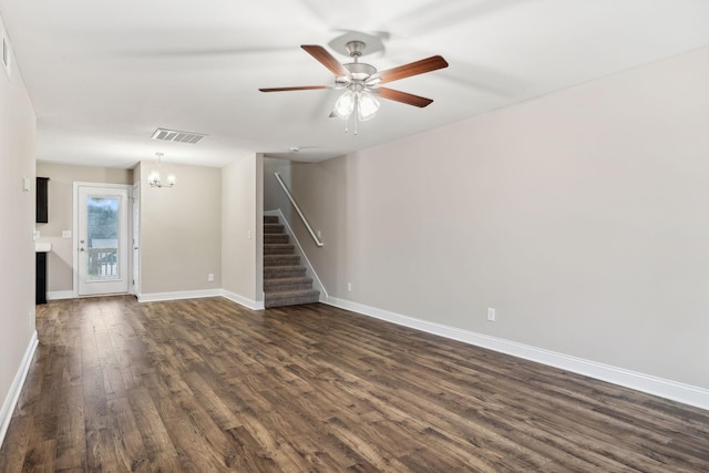 unfurnished living room with dark hardwood / wood-style floors and ceiling fan with notable chandelier