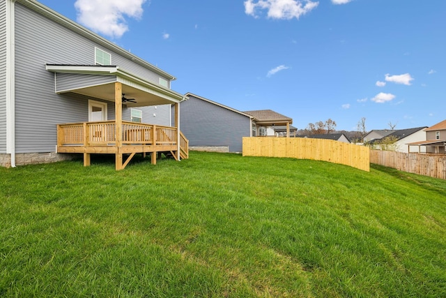 view of yard featuring ceiling fan and a wooden deck