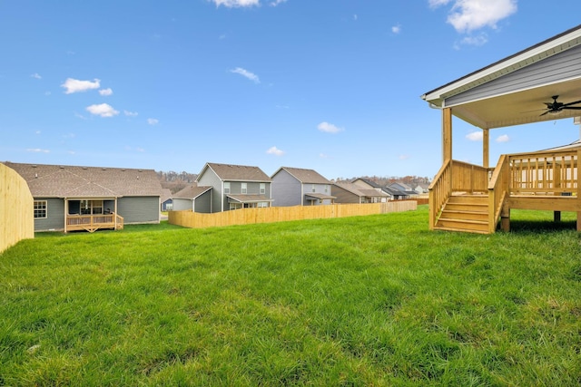 view of yard featuring a deck and ceiling fan