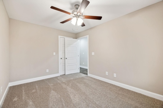 empty room with ceiling fan and carpet floors