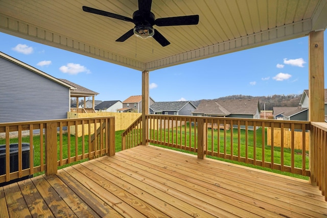 deck with central AC, ceiling fan, and a yard