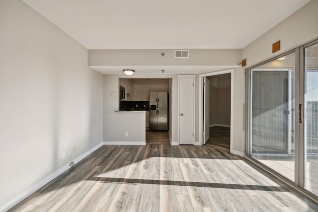 unfurnished living room featuring hardwood / wood-style floors and a healthy amount of sunlight