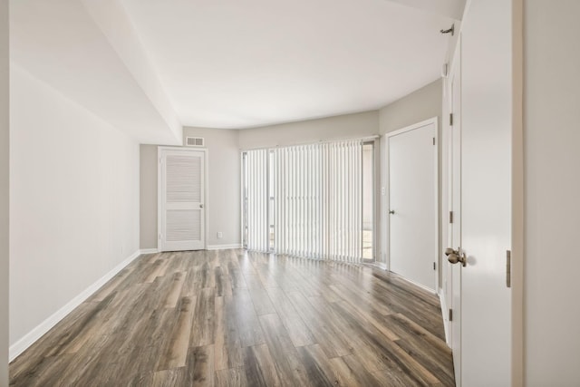 unfurnished room with dark hardwood / wood-style flooring