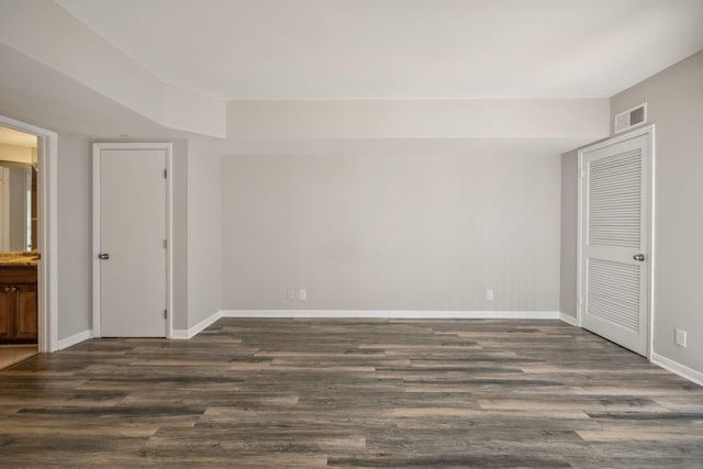 unfurnished room with dark hardwood / wood-style floors