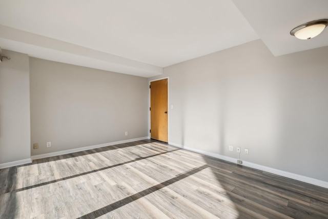 unfurnished room with hardwood / wood-style flooring