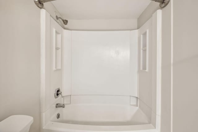 bathroom featuring toilet and bathtub / shower combination