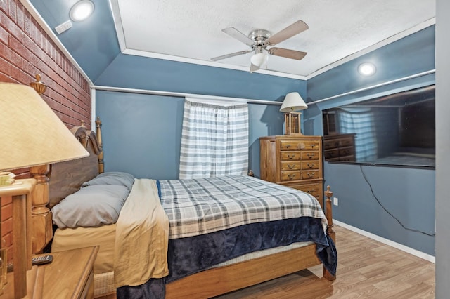 bedroom featuring ceiling fan, a textured ceiling, and light wood-type flooring