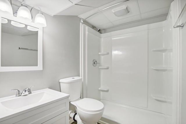 bathroom with toilet, vanity, and walk in shower