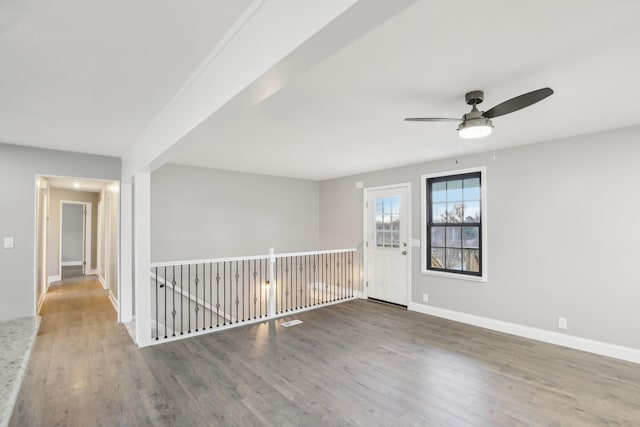 unfurnished room featuring ceiling fan and wood-type flooring