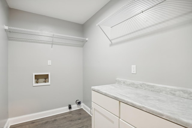 laundry room featuring cabinets, washer hookup, and dark hardwood / wood-style floors