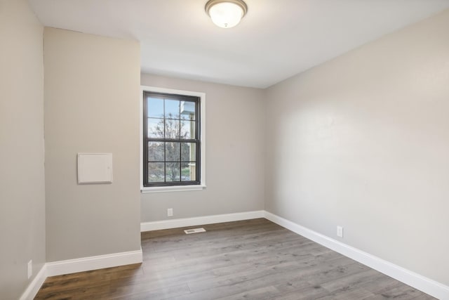 spare room with hardwood / wood-style flooring