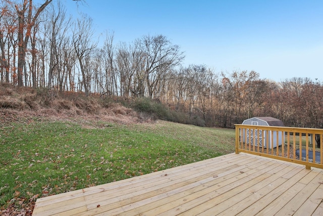 deck featuring a yard and a shed