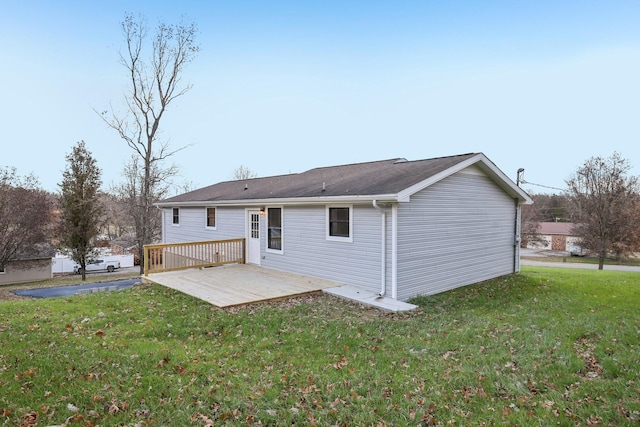 rear view of property featuring a patio area and a yard