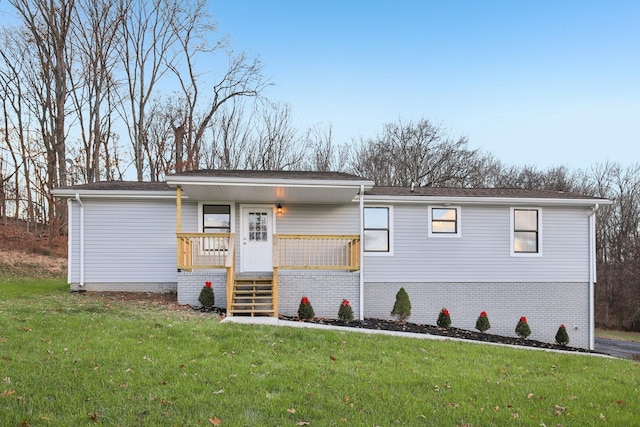 view of front of house with a porch and a front lawn