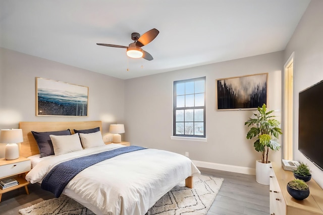 bedroom with ceiling fan and light hardwood / wood-style floors