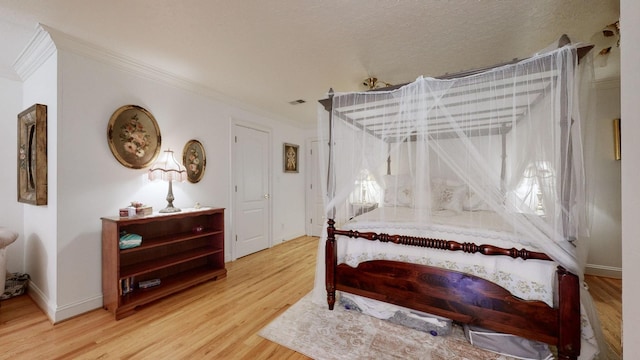 bedroom with crown molding and hardwood / wood-style flooring