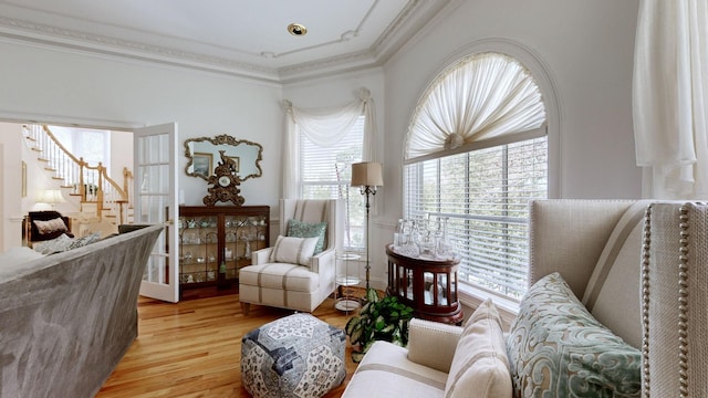 sitting room featuring light hardwood / wood-style floors and ornamental molding