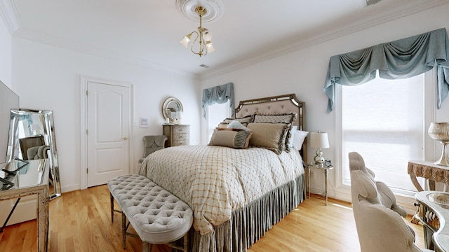 bedroom featuring a chandelier, light hardwood / wood-style floors, and crown molding