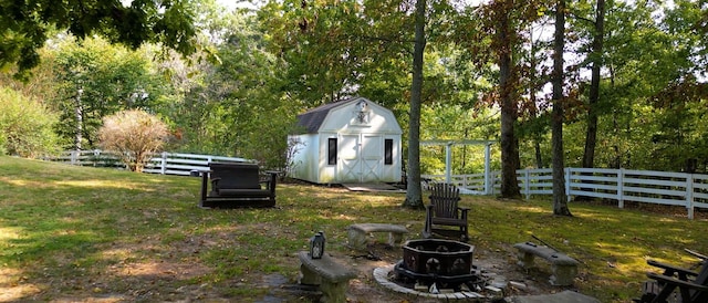 view of yard featuring a fire pit and a storage shed