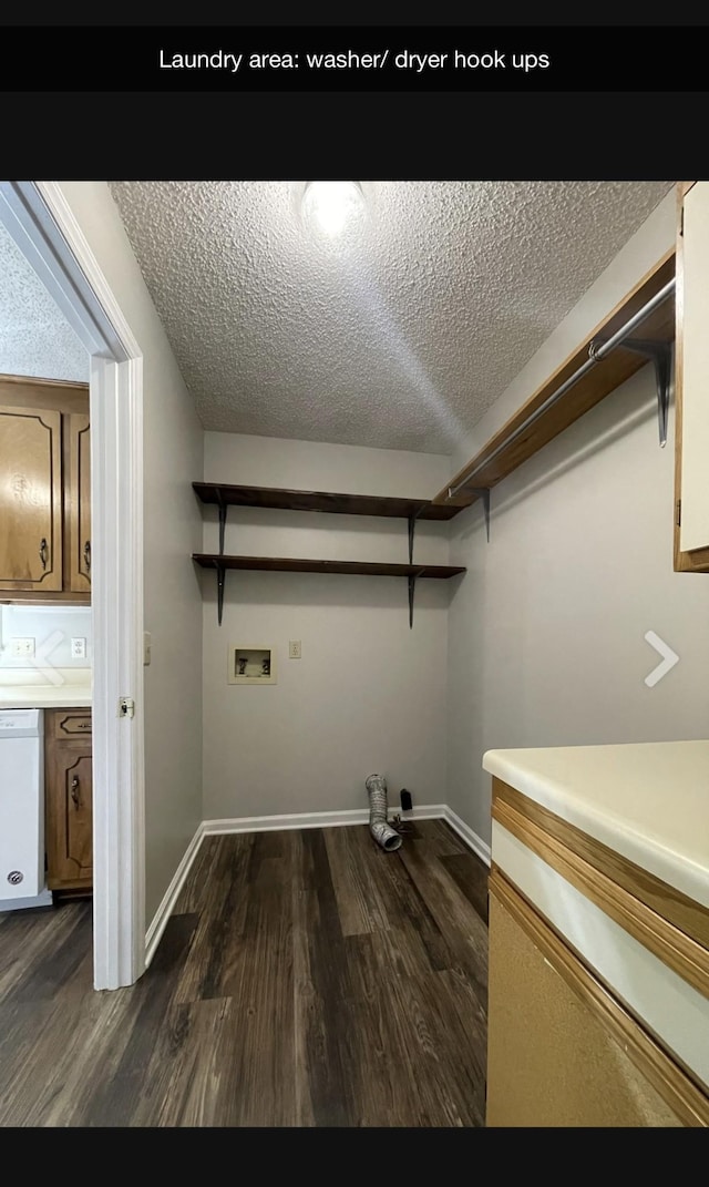 laundry area with washer hookup, dark wood-type flooring, and a textured ceiling