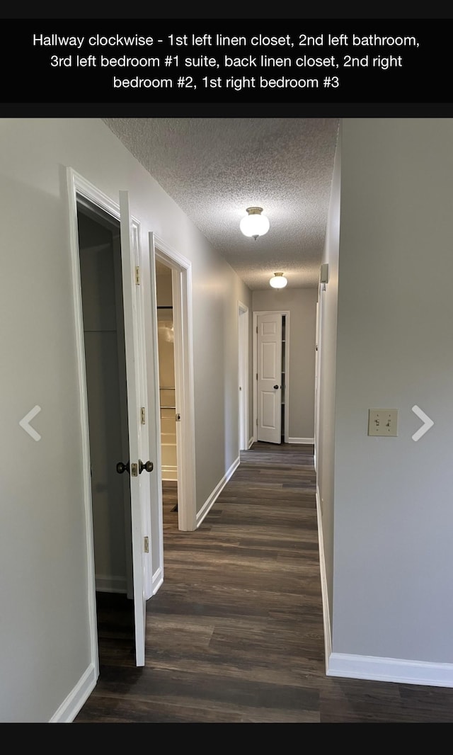 hallway with a textured ceiling and dark wood-type flooring