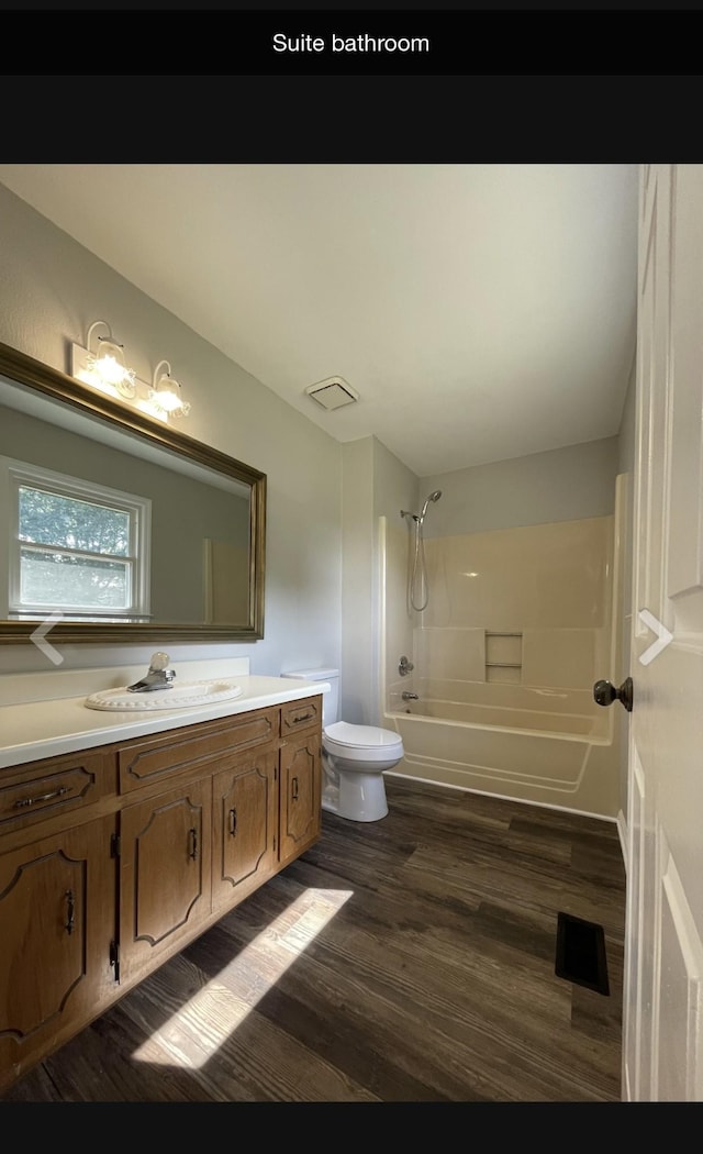 full bathroom featuring toilet, vanity, tub / shower combination, and hardwood / wood-style flooring