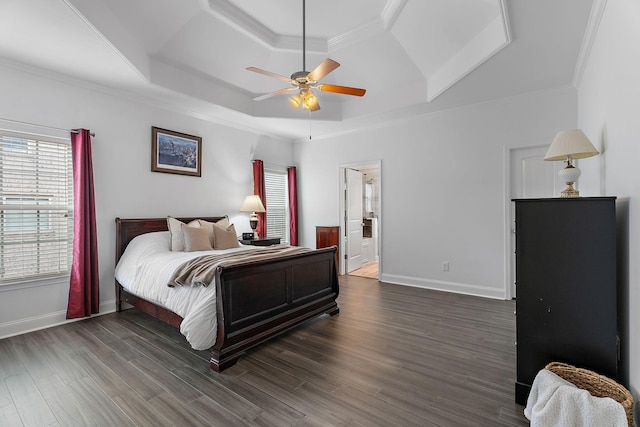 bedroom with dark hardwood / wood-style flooring, a tray ceiling, ceiling fan, and ornamental molding