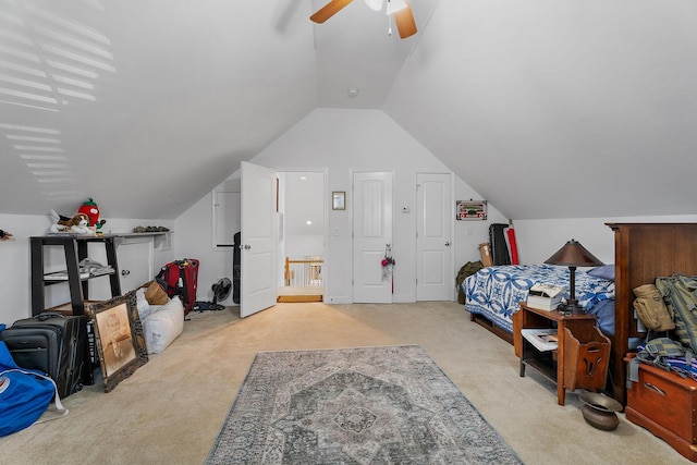 bedroom featuring ceiling fan, light colored carpet, and vaulted ceiling