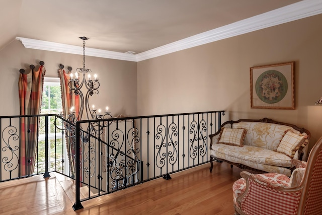 sitting room featuring crown molding, light hardwood / wood-style floors, and an inviting chandelier