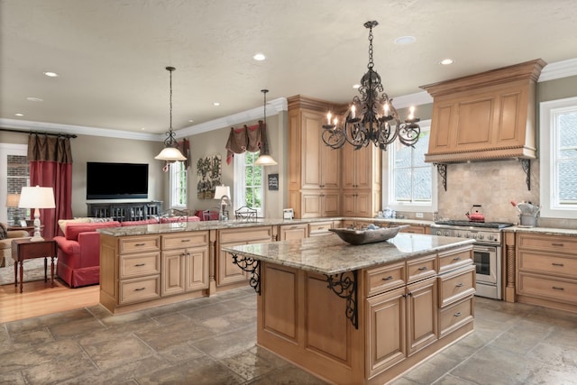 kitchen with plenty of natural light, a kitchen island, decorative backsplash, and high end stainless steel range