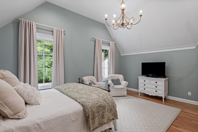 bedroom featuring multiple windows, wood-type flooring, and vaulted ceiling