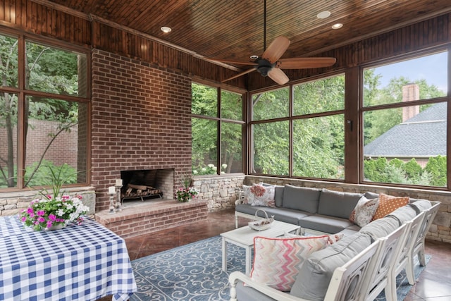 sunroom with a brick fireplace, a wealth of natural light, and wood ceiling