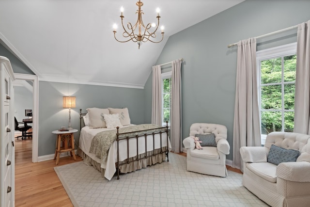 bedroom with an inviting chandelier, light wood-type flooring, lofted ceiling, and multiple windows